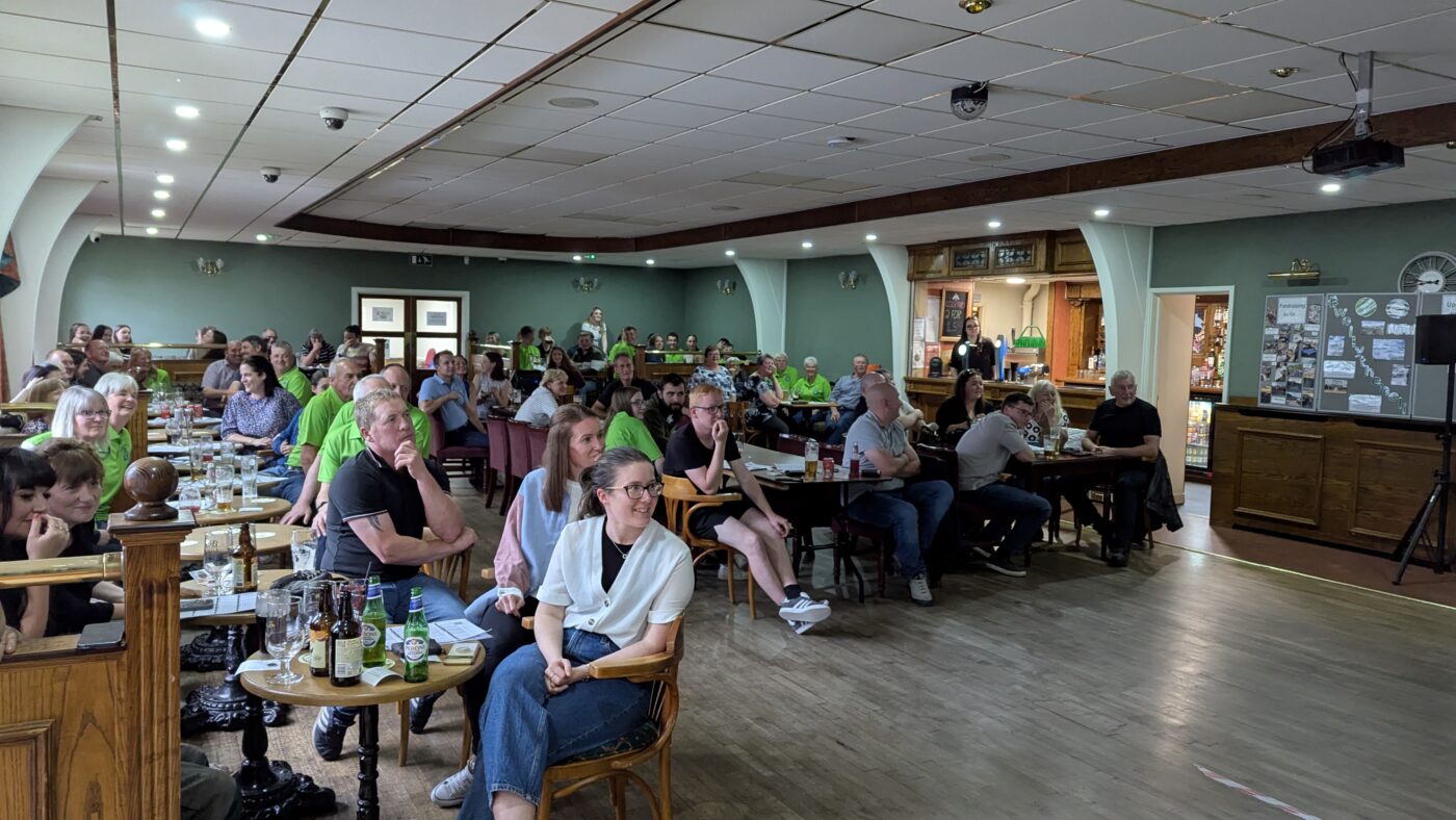 Race nigh tguests watching the race on screen